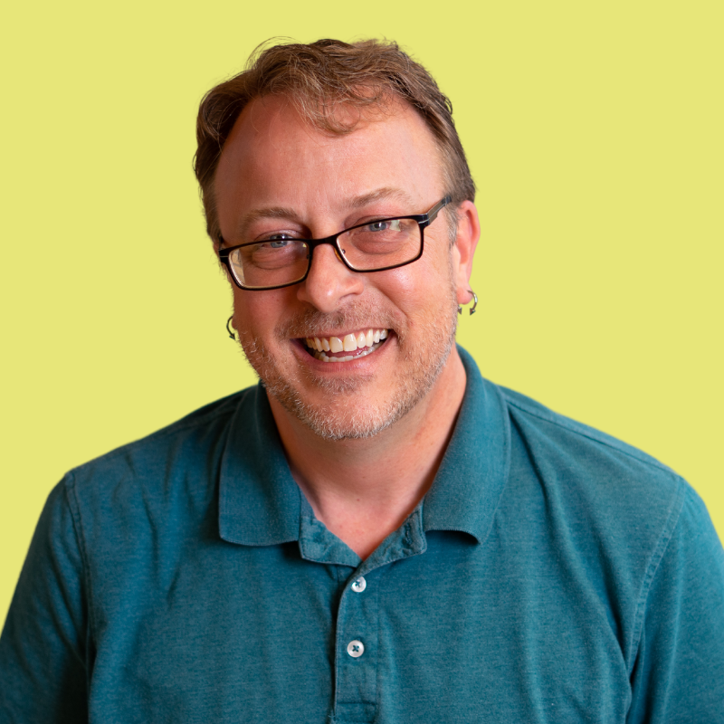 headshot of transportation consultant on yellow background