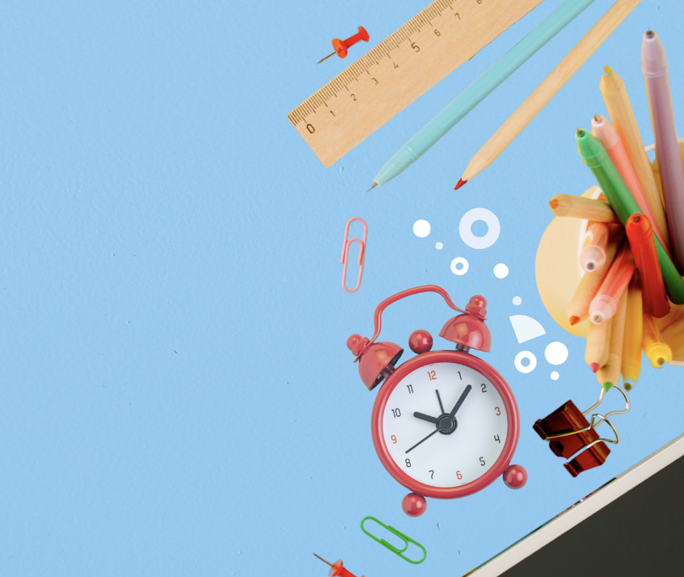 A group of school supplies including a ruler and alarm clock on a blue background.