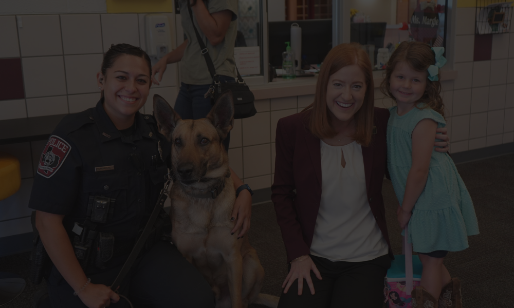 Bridgeport K9 officer and dog posing with a mother and daughter