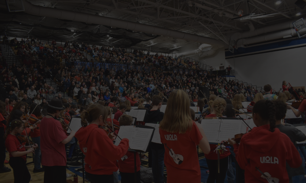 Student band performing in front of their peers in the St, Charles gymnasium