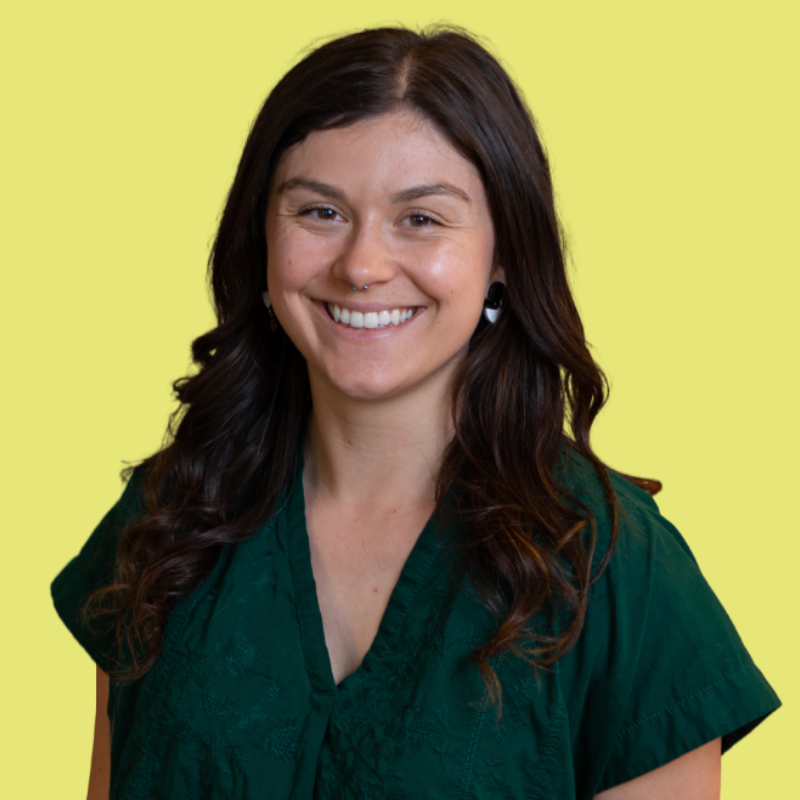 school public relations communications specialist headshot on yellow background