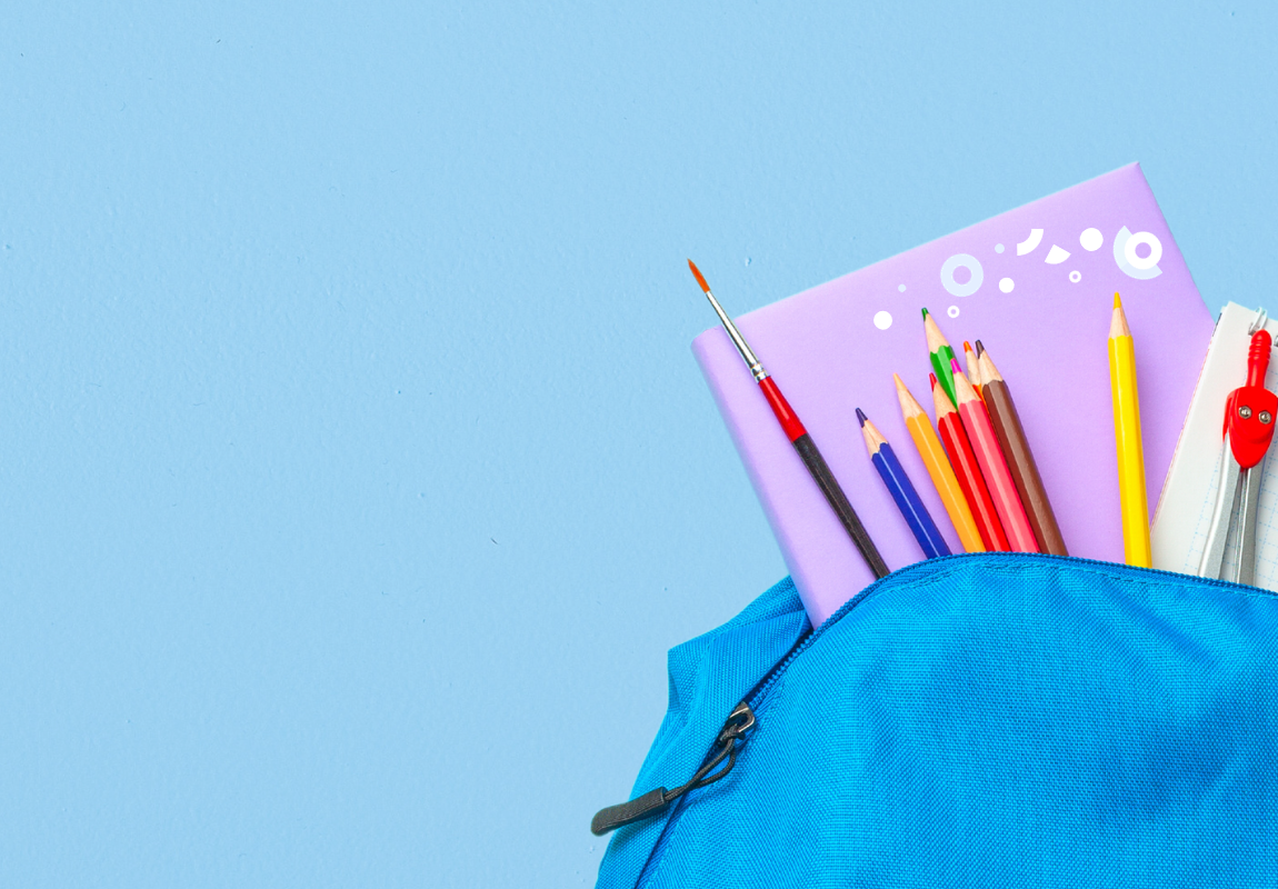light blue backpack on a blue background with a pink notebook and colored pencils spilling out of it.