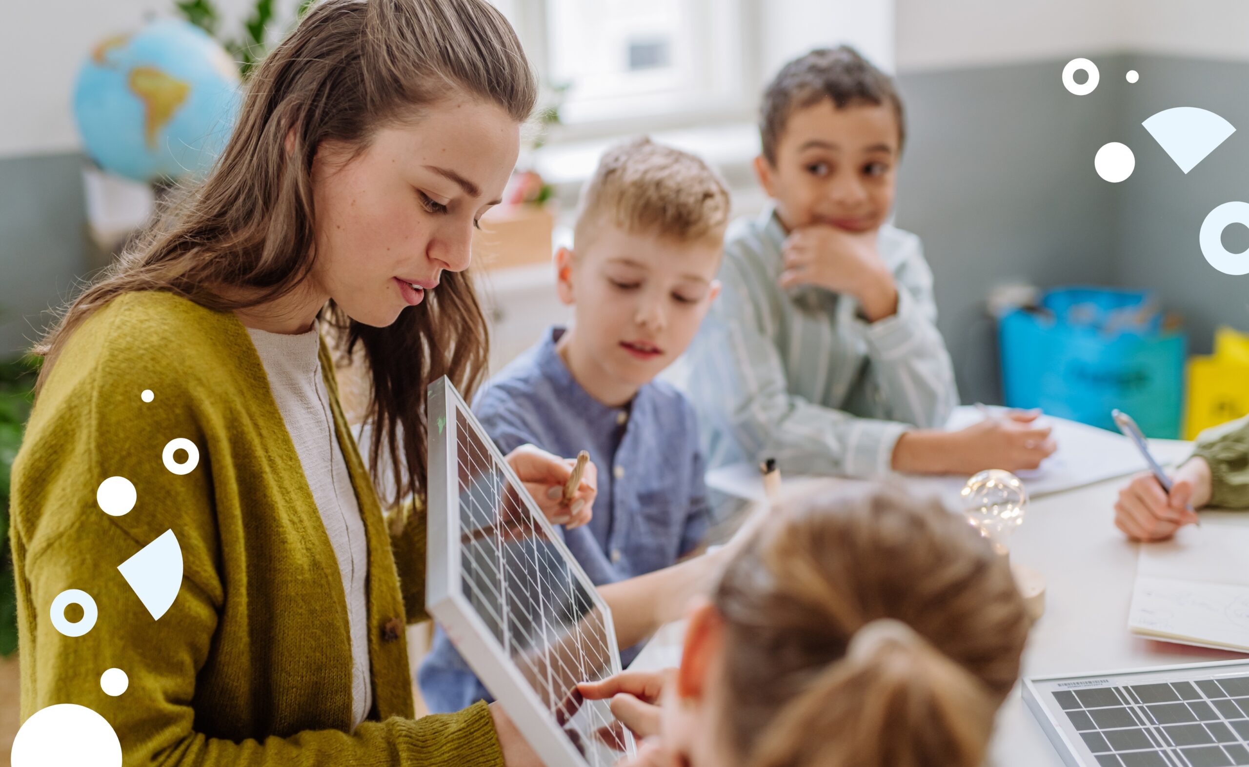 female teacher instructing group of students in classroom